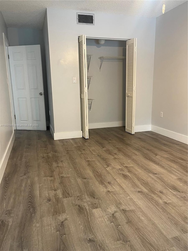 11123 SW 156th Ct, Miami, FL 33196 - unfurnished bedroom featuring wood finished floors, a closet, and a textured ceiling