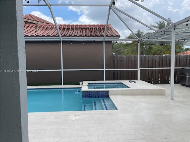 11123 SW 156th Ct, Miami, FL 33196 - view of pool featuring glass enclosure, a patio area, and a pool with connected hot tub
