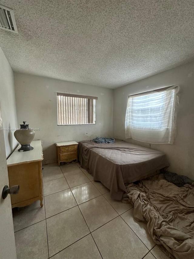 1360 SW 6th Ter, Deerfield Beach, FL 33441 - bedroom featuring a textured ceiling and light tile patterned floors