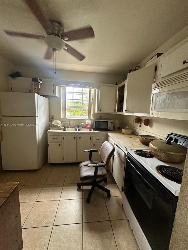 1360 SW 6th Ter, Deerfield Beach, FL 33441 - kitchen with white appliances, light countertops, light tile patterned flooring, and ceiling fan