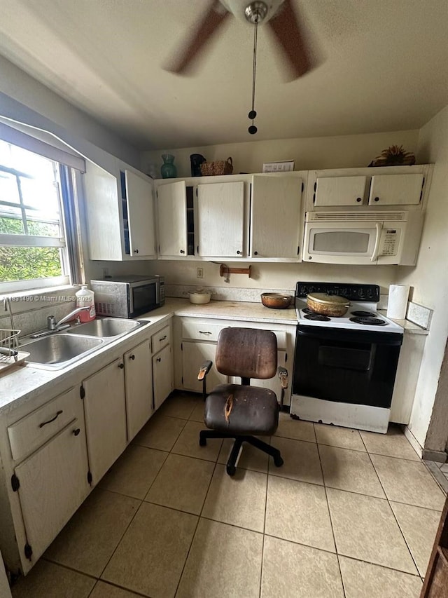 1360 SW 6th Ter, Deerfield Beach, FL 33441 - kitchen featuring range with electric cooktop, white microwave, stainless steel microwave, light countertops, and light tile patterned floors