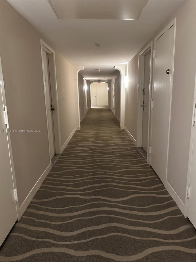 2333 Brickell Ave Unit 901, Miami, FL 33129 - corridor featuring dark carpet and baseboards