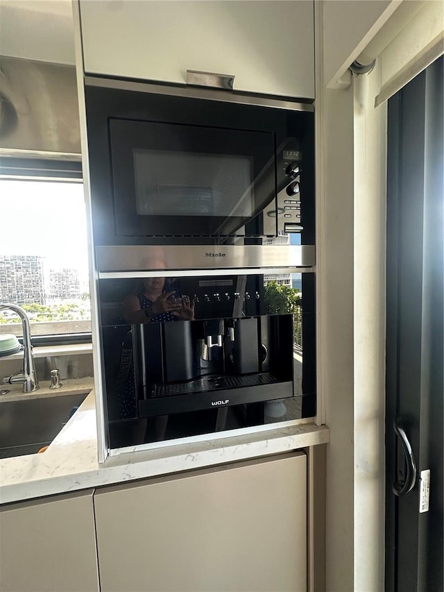 2333 Brickell Ave Unit 901, Miami, FL 33129 - kitchen view of a sink and light stone countertops