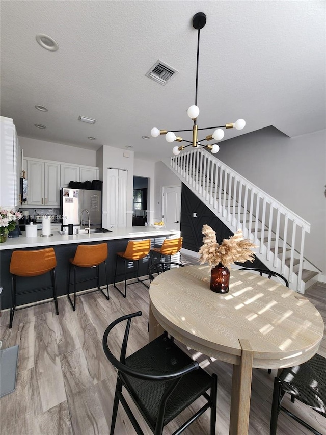 706 SW 147th Ave, Pembroke Pines, FL 33027 - dining area with stairs and a chandelier