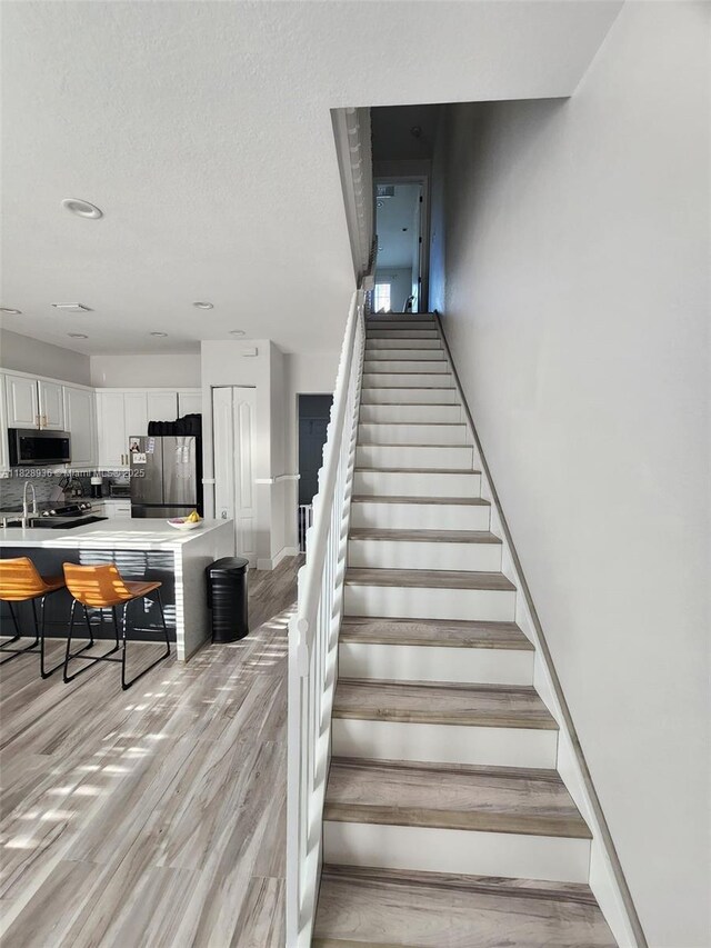 706 SW 147th Ave, Pembroke Pines, FL 33027 - staircase with wood finished floors and recessed lighting
