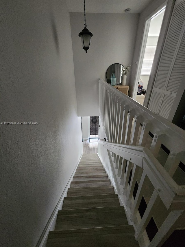 706 SW 147th Ave, Pembroke Pines, FL 33027 - stairway featuring wood finished floors and a textured wall