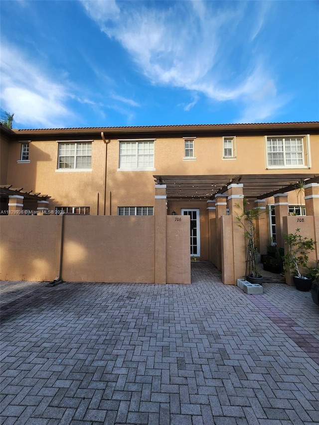 706 SW 147th Ave, Pembroke Pines, FL 33027 - view of front of home featuring stucco siding, a pergola, and a patio area