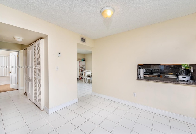 10114 NW 4th Ln Unit 3-12, Miami, FL 33172 - spare room with light tile patterned floors and a textured ceiling