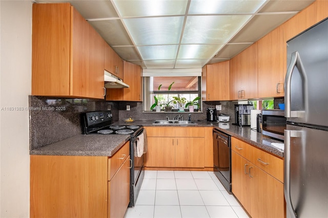 10114 NW 4th Ln Unit 3-12, Miami, FL 33172 - kitchen featuring black appliances, under cabinet range hood, decorative backsplash, light tile patterned floors, and dark stone counters