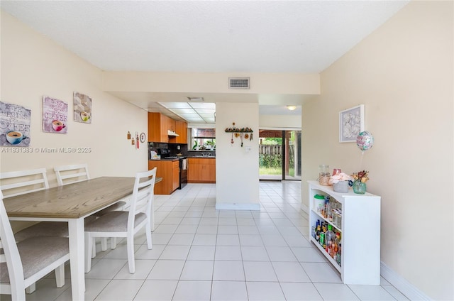 10114 NW 4th Ln Unit 3-12, Miami, FL 33172 - dining room featuring baseboards and light tile patterned floors