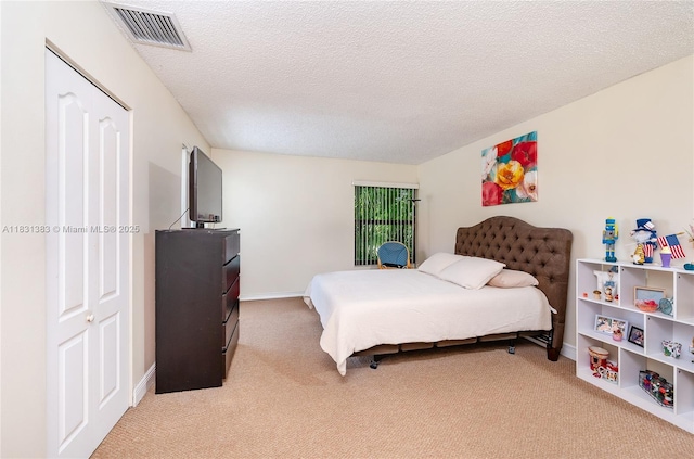 10114 NW 4th Ln Unit 3-12, Miami, FL 33172 - bedroom featuring light carpet and a textured ceiling