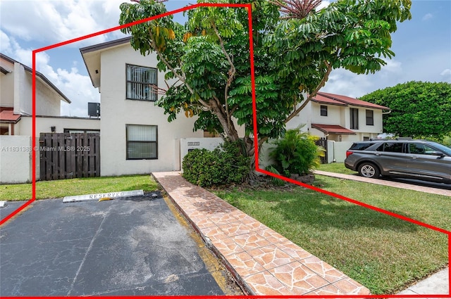 10114 NW 4th Ln Unit 3-12, Miami, FL 33172 - view of property featuring stucco siding and uncovered parking