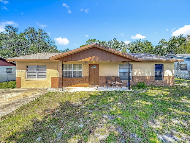 1206 E 27th St, Bradenton, FL 34208 - single story home with stone siding, a front lawn, and stucco siding