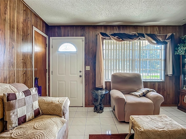 1206 E 27th St, Bradenton, FL 34208 - foyer featuring wooden walls, a textured ceiling, and light tile patterned flooring