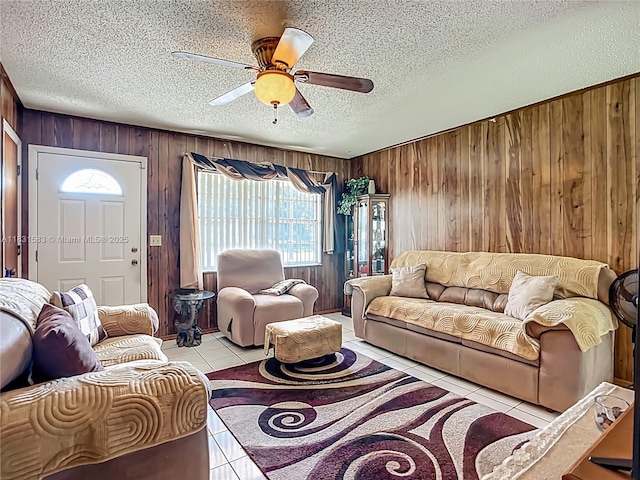 1206 E 27th St, Bradenton, FL 34208 - tiled living area featuring wood walls, a textured ceiling, and ceiling fan