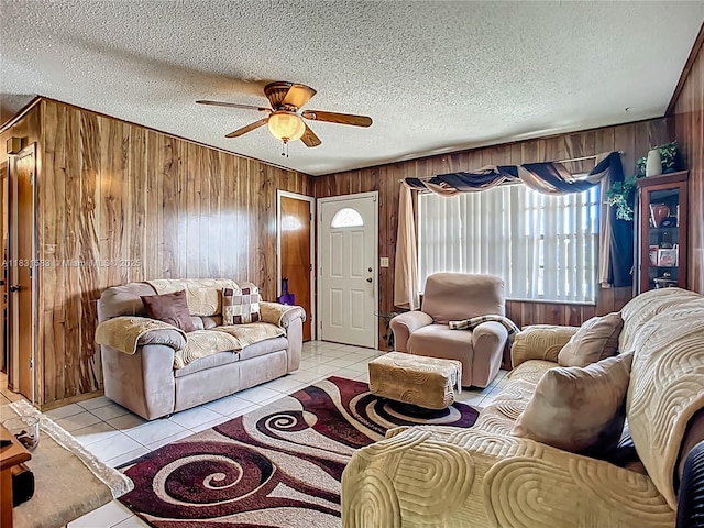 1206 E 27th St, Bradenton, FL 34208 - living room with wood walls, a ceiling fan, light tile patterned flooring, and a textured ceiling