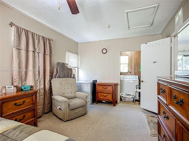 1206 E 27th St, Bradenton, FL 34208 - carpeted bedroom with multiple windows, washer and dryer, attic access, ceiling fan, and a textured ceiling