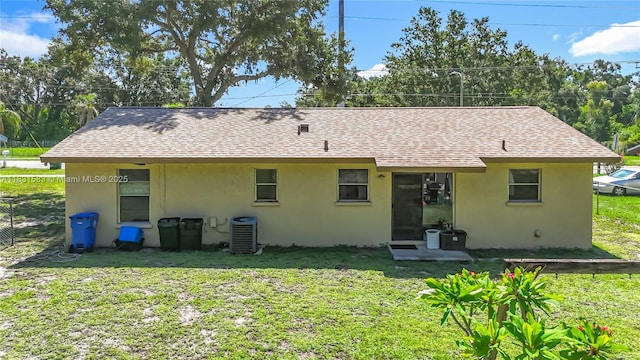 1206 E 27th St, Bradenton, FL 34208 - rear view of house featuring stucco siding, a lawn, and a shingled roof