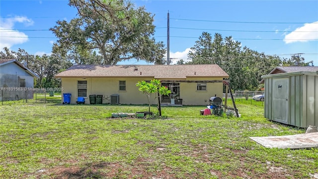 1206 E 27th St, Bradenton, FL 34208 - rear view of house with stucco siding, a fenced backyard, and a storage unit
