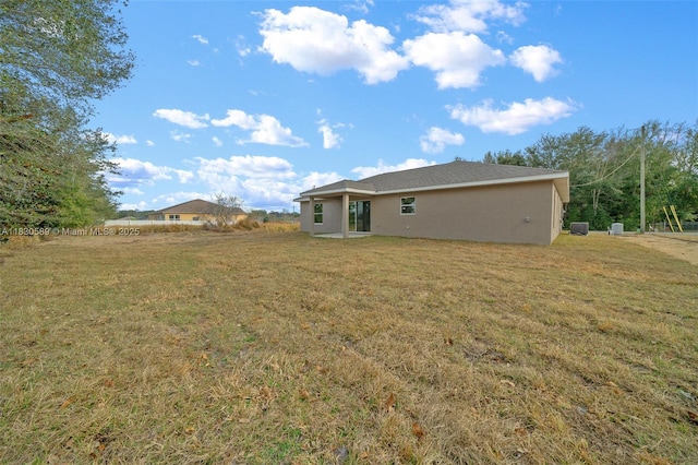7 Dogwood Trail Run, Ocala, FL 34472 - rear view of property with a yard and stucco siding