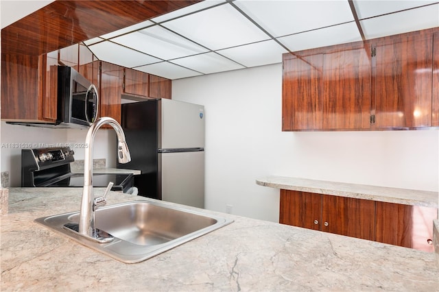 20905 NE 8th Ct Unit 101-36, Miami, FL 33179 - kitchen with stainless steel appliances, brown cabinets, and light countertops