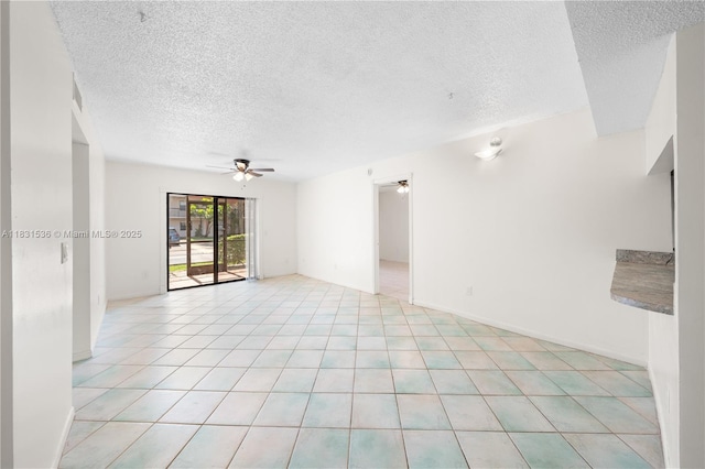20905 NE 8th Ct Unit 101-36, Miami, FL 33179 - empty room featuring a ceiling fan, a textured ceiling, and light tile patterned floors