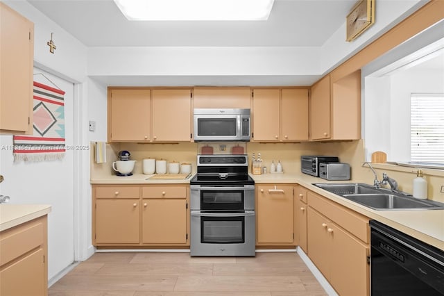 2015 N 37th Ave, Hollywood, FL 33021 - kitchen featuring stainless steel appliances, light wood-style floors, and light countertops