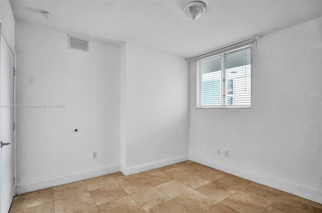 6305 Indian Creek Dr Unit 3B, Miami Beach, FL 33141 - spare room featuring a smoke detector and baseboards