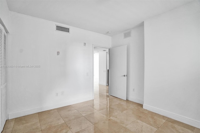 6305 Indian Creek Dr Unit 3B, Miami Beach, FL 33141 - spare room featuring light tile patterned floors and baseboards