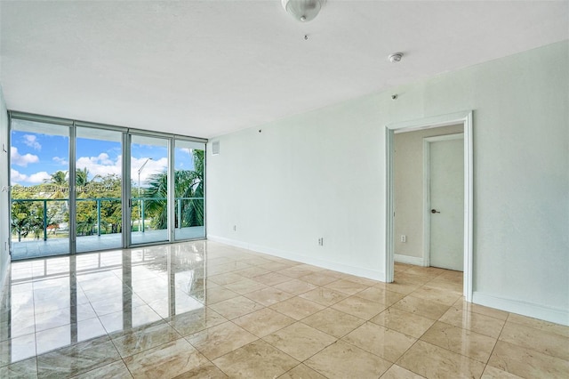 6305 Indian Creek Dr Unit 3B, Miami Beach, FL 33141 - empty room featuring floor to ceiling windows, a smoke detector, and light tile patterned floors
