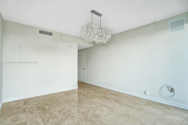 6305 Indian Creek Dr Unit 3B, Miami Beach, FL 33141 - spare room featuring a chandelier and baseboards