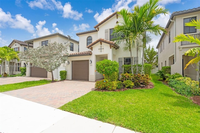 3274 W 96th Pl, Hialeah, FL 33018 - mediterranean / spanish house with a tile roof, decorative driveway, stucco siding, and a front yard