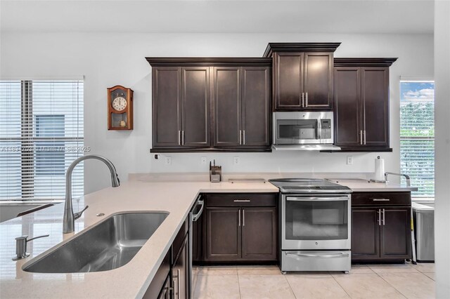 3274 W 96th Pl, Hialeah, FL 33018 - kitchen featuring appliances with stainless steel finishes, dark brown cabinets, and light tile patterned floors