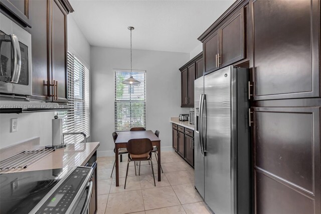 3274 W 96th Pl, Hialeah, FL 33018 - kitchen with stainless steel appliances, dark brown cabinets, light tile patterned flooring, decorative light fixtures, and light countertops