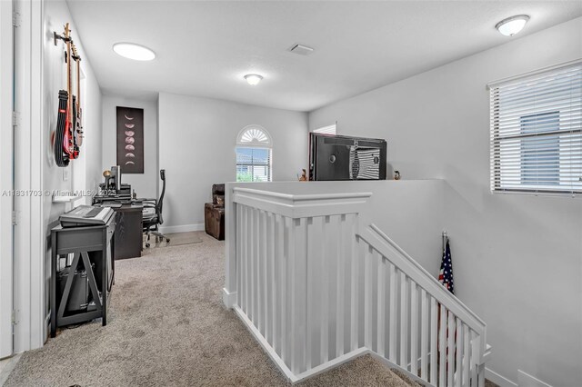 3274 W 96th Pl, Hialeah, FL 33018 - hall with an upstairs landing, carpet flooring, and a desk
