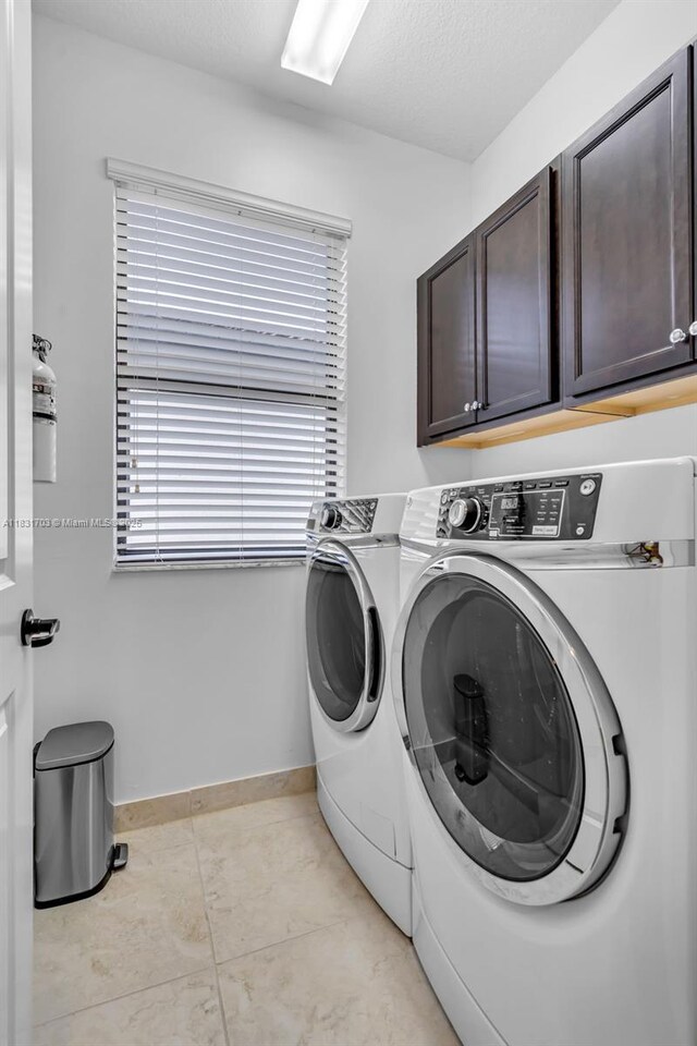 3274 W 96th Pl, Hialeah, FL 33018 - laundry area with cabinet space, independent washer and dryer, and light tile patterned floors