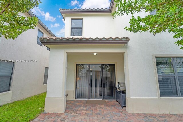 3274 W 96th Pl, Hialeah, FL 33018 - doorway to property with stucco siding and a tile roof