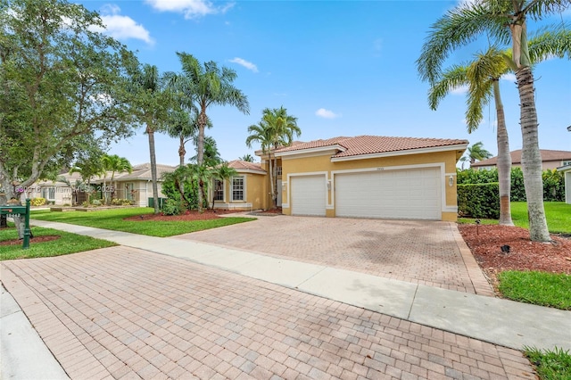 19442 SW 39th St, Miramar, FL 33029 - view of front of house with stucco siding, decorative driveway, a tiled roof, an attached garage, and a front yard