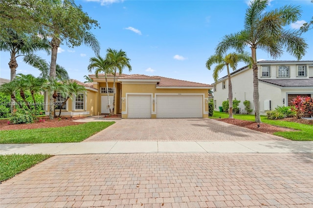 19442 SW 39th St, Miramar, FL 33029 - mediterranean / spanish-style house featuring stucco siding, decorative driveway, a tile roof, and an attached garage