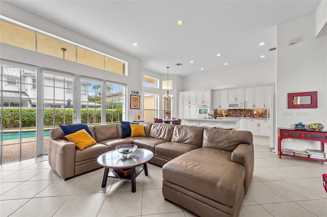 19442 SW 39th St, Miramar, FL 33029 - living area with a high ceiling, light tile patterned floors, recessed lighting, and a chandelier