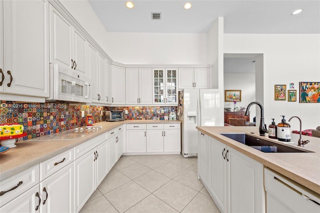 19442 SW 39th St, Miramar, FL 33029 - kitchen with white appliances, light tile patterned flooring, white cabinets, and recessed lighting