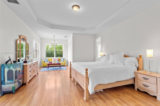 19442 SW 39th St, Miramar, FL 33029 - bedroom with a chandelier, light wood-style floors, and a tray ceiling