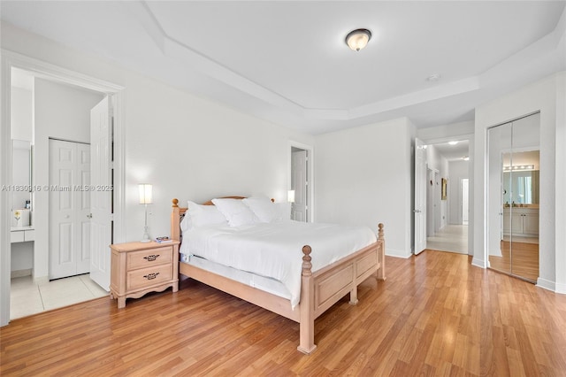 19442 SW 39th St, Miramar, FL 33029 - bedroom featuring light wood-style flooring, a raised ceiling, and ensuite bathroom