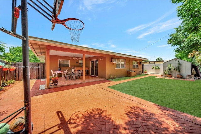 2201 N 57th Ter, Hollywood, FL 33021 - rear view of property featuring a ceiling fan, a shed, a patio area, stucco siding, and outdoor dining space
