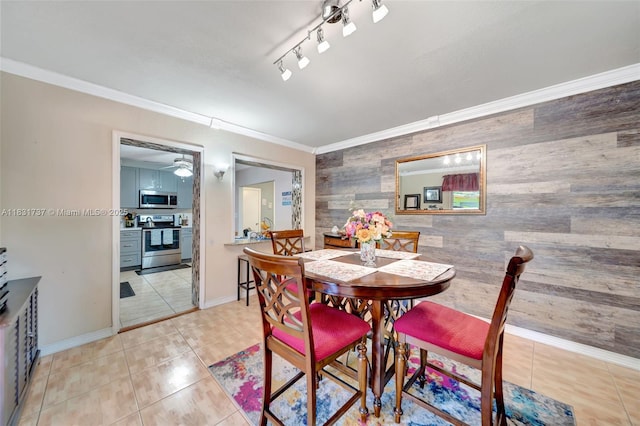 2201 N 57th Ter, Hollywood, FL 33021 - dining space with an accent wall, wooden walls, crown molding, light tile patterned flooring, and a ceiling fan