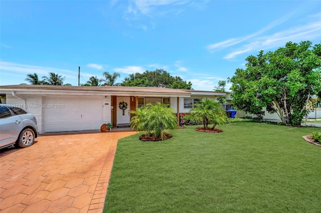 2201 N 57th Ter, Hollywood, FL 33021 - ranch-style home with an attached garage, decorative driveway, and a front yard
