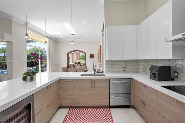 2541 Golf View Dr, Weston, FL 33327 - kitchen featuring wall chimney exhaust hood, ornamental molding, appliances with stainless steel finishes, a kitchen breakfast bar, and light countertops