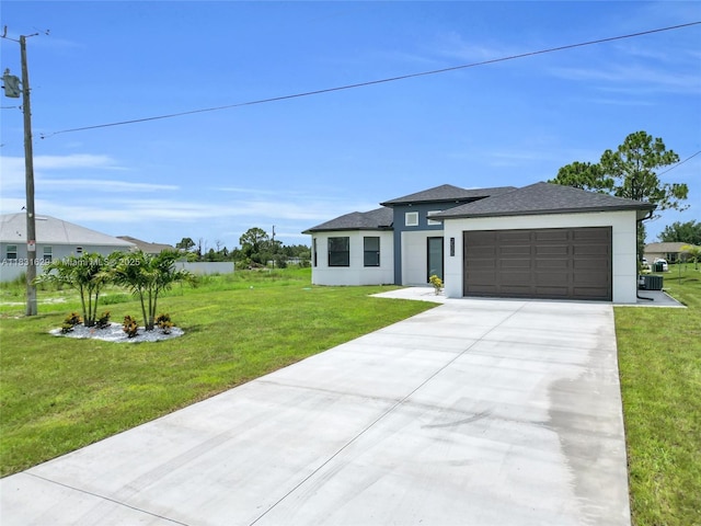2505 40th, Lehigh Acres, FL 33976 - prairie-style house with stucco siding, a garage, concrete driveway, and a front lawn