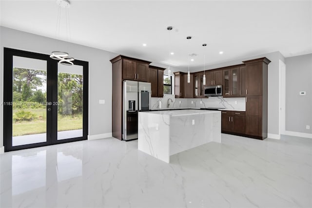 2505 40th, Lehigh Acres, FL 33976 - kitchen with appliances with stainless steel finishes, dark brown cabinetry, recessed lighting, a kitchen island, and glass insert cabinets
