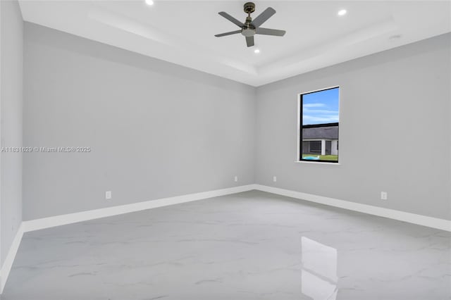 2505 40th, Lehigh Acres, FL 33976 - empty room featuring a tray ceiling, marble finish flooring, recessed lighting, and ceiling fan
